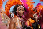 A dancer performs during the the Notting Hill Carnival in west London. (Photo by Hollie Adams/PA Images via Getty Images)